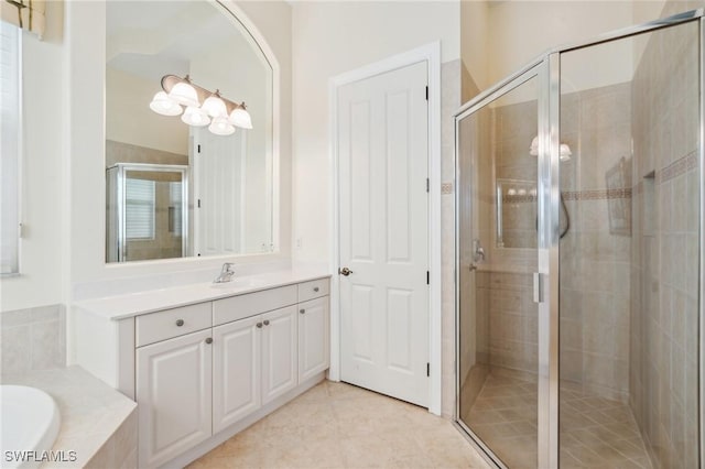 bathroom with vanity and independent shower and bath