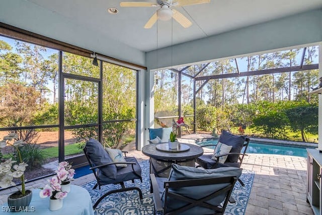 sunroom / solarium featuring ceiling fan and a swimming pool