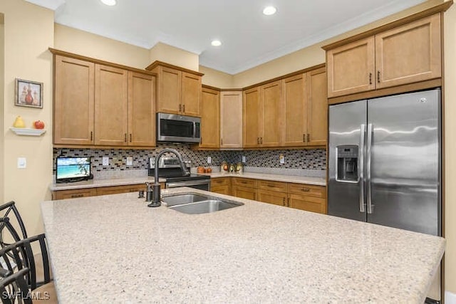 kitchen featuring light stone countertops, a kitchen breakfast bar, backsplash, stainless steel appliances, and sink