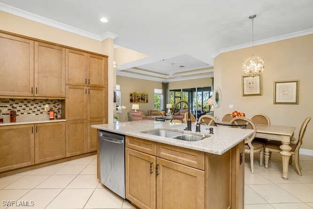 kitchen featuring stainless steel dishwasher, ornamental molding, sink, decorative light fixtures, and an island with sink