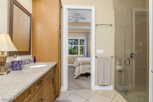 bathroom with tile patterned flooring, vanity, ceiling fan, and walk in shower