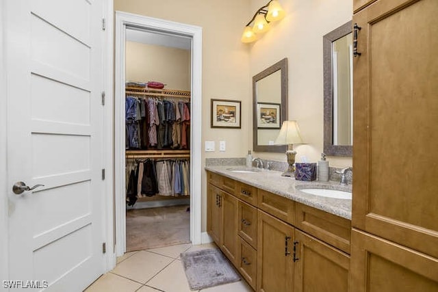 bathroom with tile patterned floors and vanity