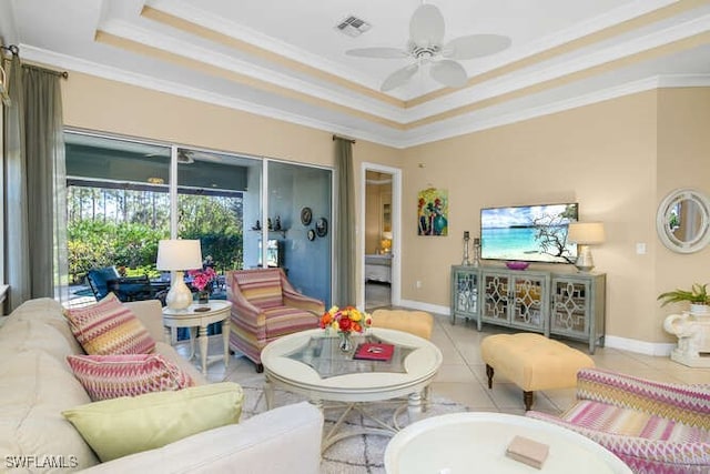 tiled living room featuring ceiling fan, crown molding, and a tray ceiling