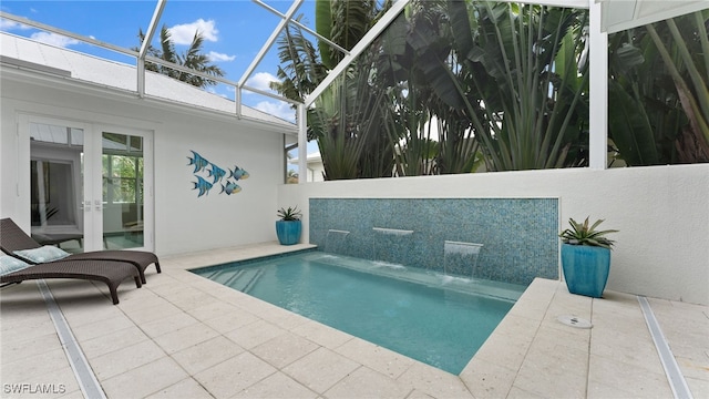 view of swimming pool with a lanai, pool water feature, and a patio