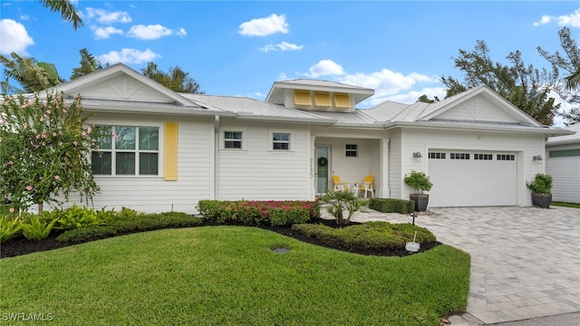 view of front facade with a front yard and a garage