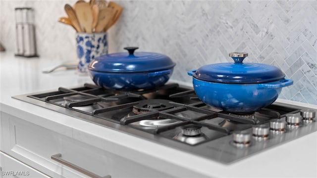 details featuring white cabinets and stainless steel gas stovetop