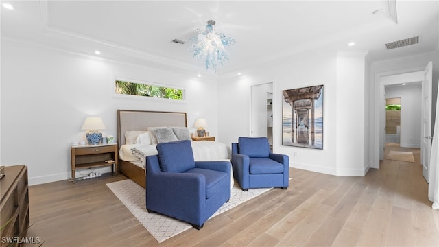 bedroom featuring crown molding and light hardwood / wood-style flooring