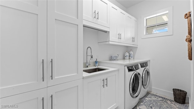 laundry room featuring cabinets, washer and dryer, and sink