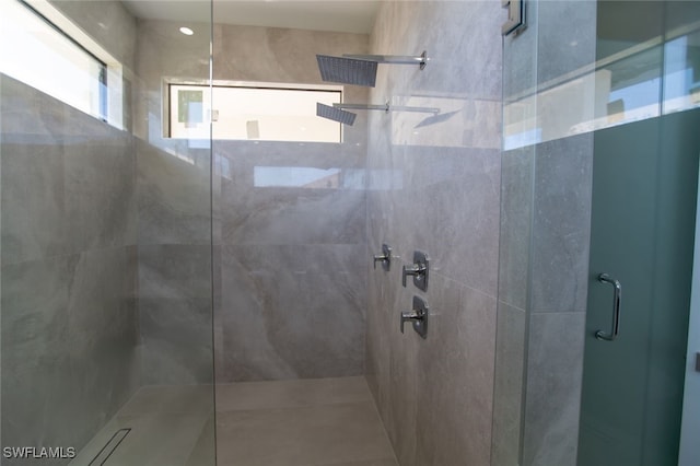 bathroom featuring a shower with door