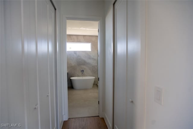 corridor with light hardwood / wood-style flooring