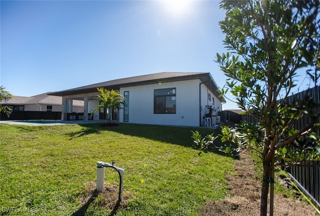 back of house featuring a yard