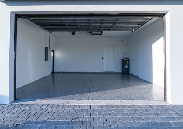 garage featuring a garage door opener, electric panel, and electric water heater