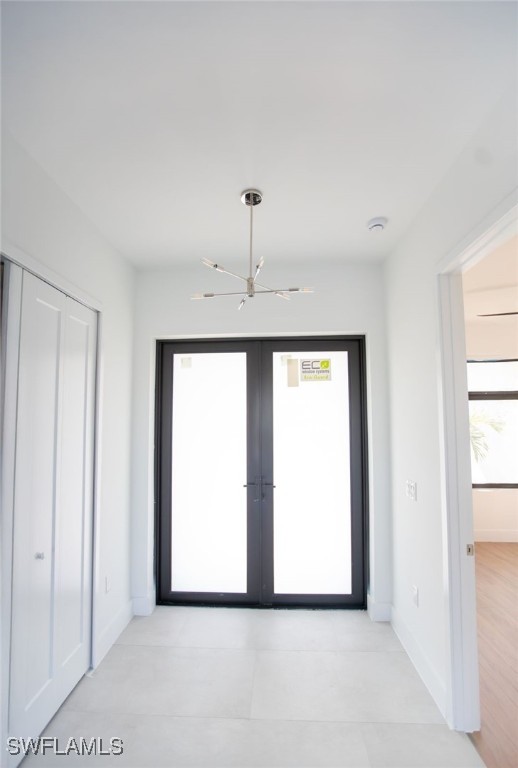 interior space with ceiling fan and french doors