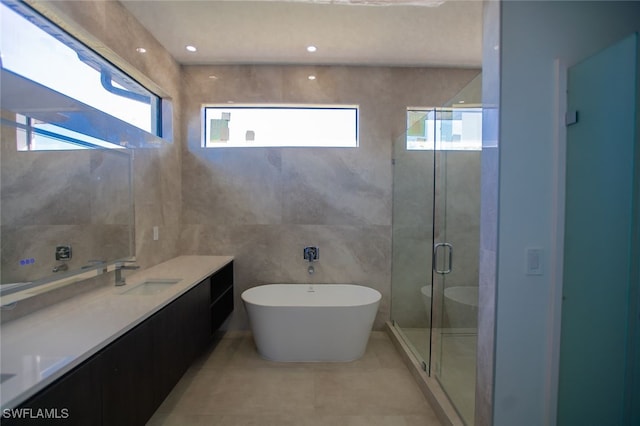 bathroom featuring vanity, a wealth of natural light, and shower with separate bathtub