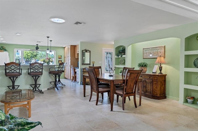 dining space featuring built in shelves