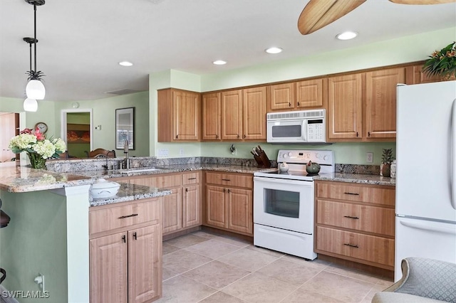 kitchen with light stone countertops, sink, hanging light fixtures, white appliances, and light tile patterned flooring