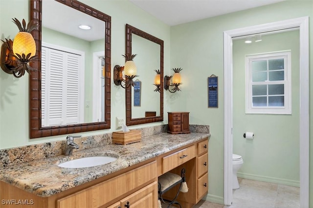 bathroom with tile patterned floors, vanity, and toilet