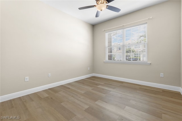 empty room with ceiling fan and light hardwood / wood-style floors