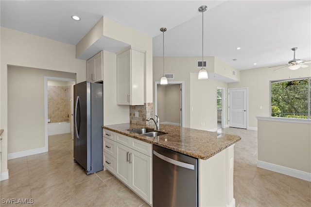 kitchen with ceiling fan, white cabinetry, stainless steel appliances, and dark stone counters