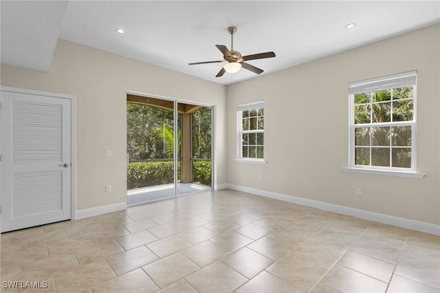 spare room with ceiling fan, plenty of natural light, and light tile patterned floors