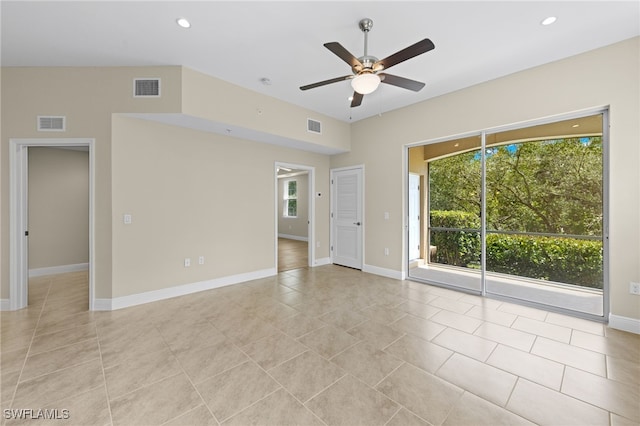 empty room featuring light tile patterned flooring, a wealth of natural light, and ceiling fan