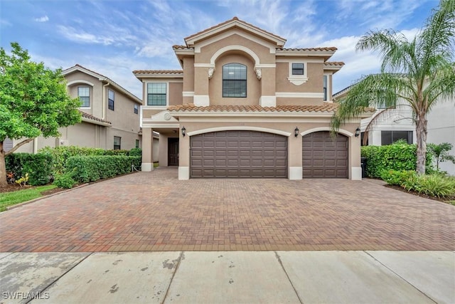 mediterranean / spanish house featuring a garage