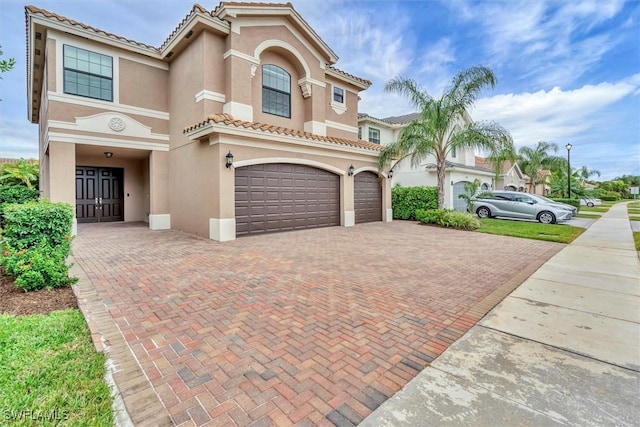 mediterranean / spanish-style house with a garage