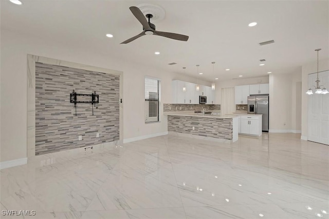 unfurnished living room featuring ceiling fan