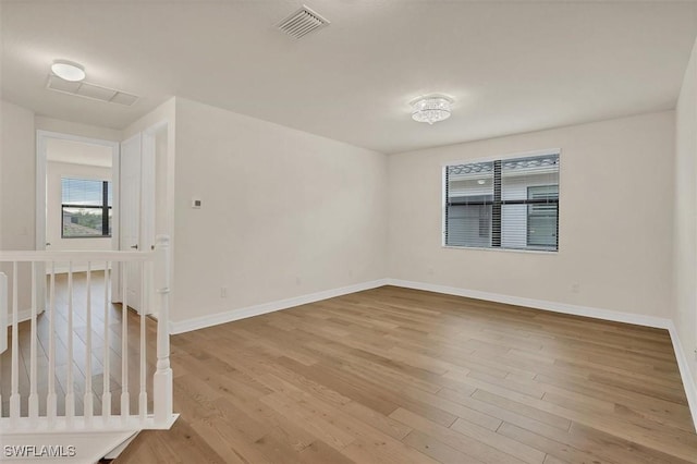 unfurnished room with light wood-type flooring