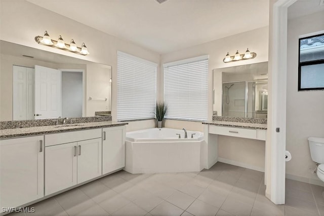 full bathroom featuring tile patterned floors, vanity, toilet, and independent shower and bath