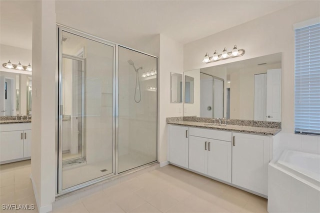 bathroom featuring vanity and separate shower and tub