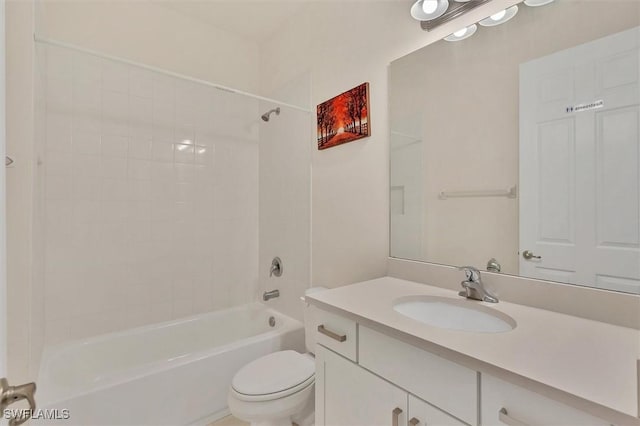 full bathroom with toilet, vanity, and tiled shower / bath