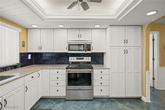 kitchen featuring white cabinets, a raised ceiling, and electric stove