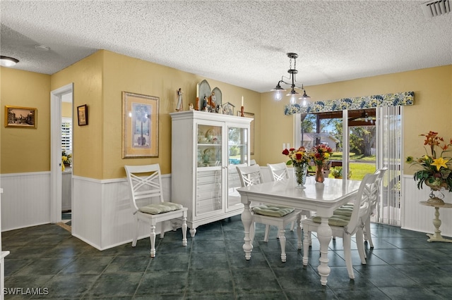 dining area featuring a textured ceiling