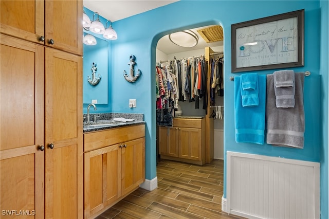 bathroom with vanity and hardwood / wood-style flooring