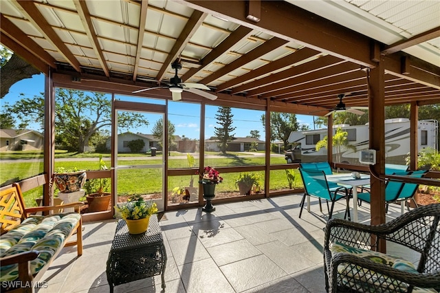 sunroom featuring ceiling fan