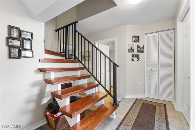 stairway featuring tile patterned floors