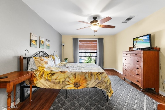 bedroom featuring ceiling fan and dark hardwood / wood-style floors