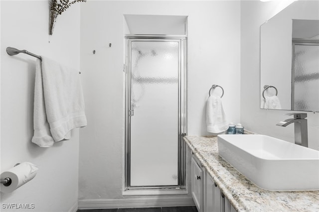 bathroom featuring vanity and an enclosed shower