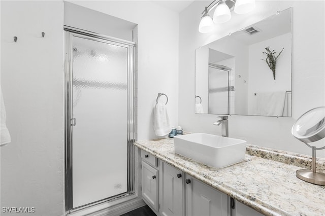 bathroom with vanity and an enclosed shower