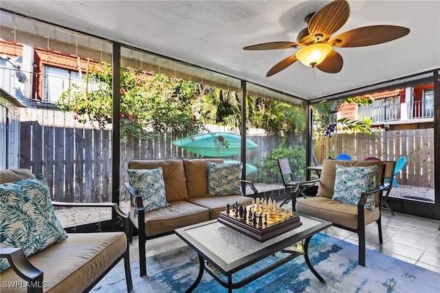 sunroom featuring ceiling fan