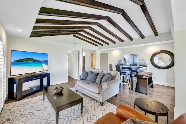 living room featuring vaulted ceiling with beams and light hardwood / wood-style flooring