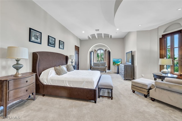 bedroom featuring light colored carpet