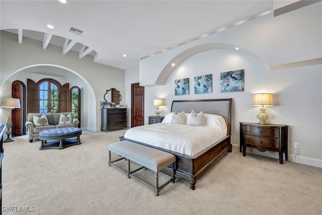 carpeted bedroom with lofted ceiling with beams