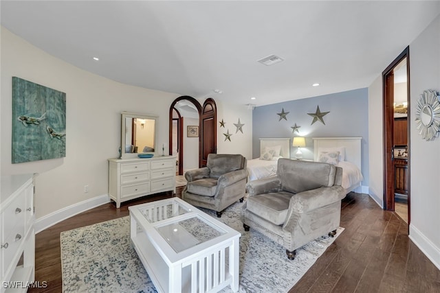 bedroom with dark hardwood / wood-style flooring