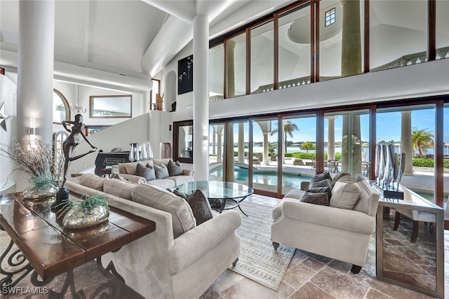 living room featuring high vaulted ceiling