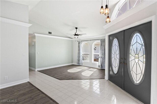 entrance foyer featuring hardwood / wood-style flooring, ceiling fan, ornamental molding, and french doors