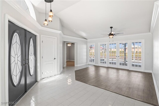 tiled foyer featuring french doors, ceiling fan, lofted ceiling, and ornamental molding