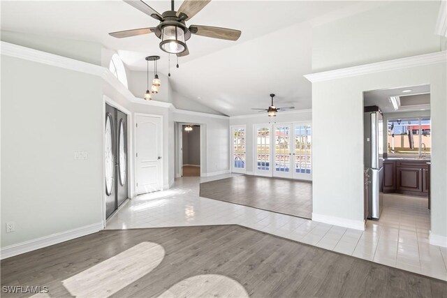 interior space featuring hardwood / wood-style floors, lofted ceiling, ornamental molding, ceiling fan, and french doors