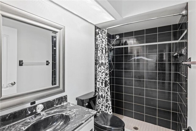 bathroom featuring walk in shower, vanity, and toilet